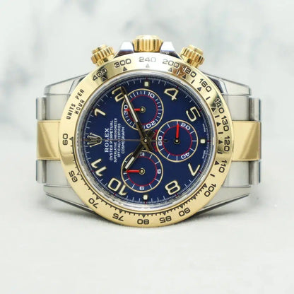 Rolex  Daytona featuring a two-tone stainless steel and yellow gold finish with a distinctive blue dial