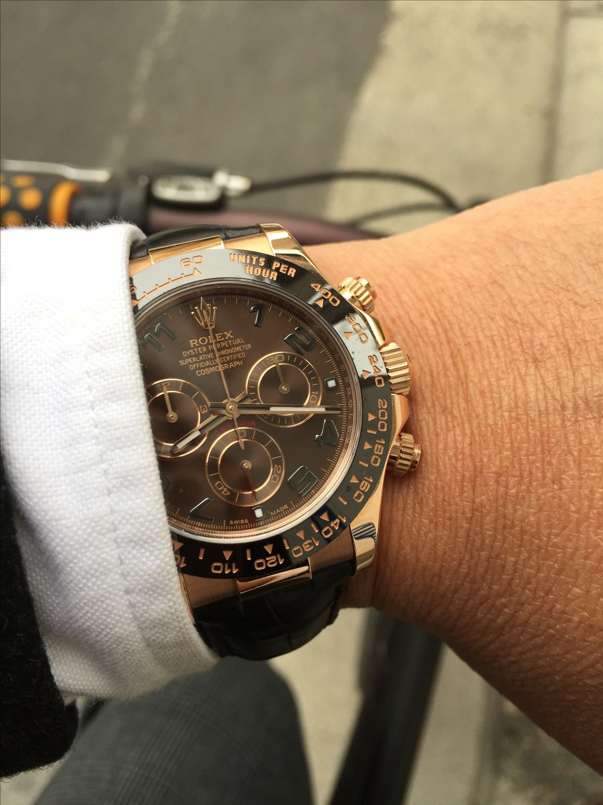 Rolex  Daytona model 116515LN featuring a Rose gold case, a chocolate dial , a black bezel, and a black leather strap.
