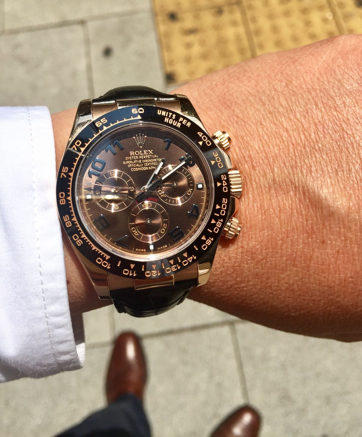 Rolex  Daytona model 116515LN featuring a Rose gold case, a chocolate dial , a black bezel, and a black leather strap.