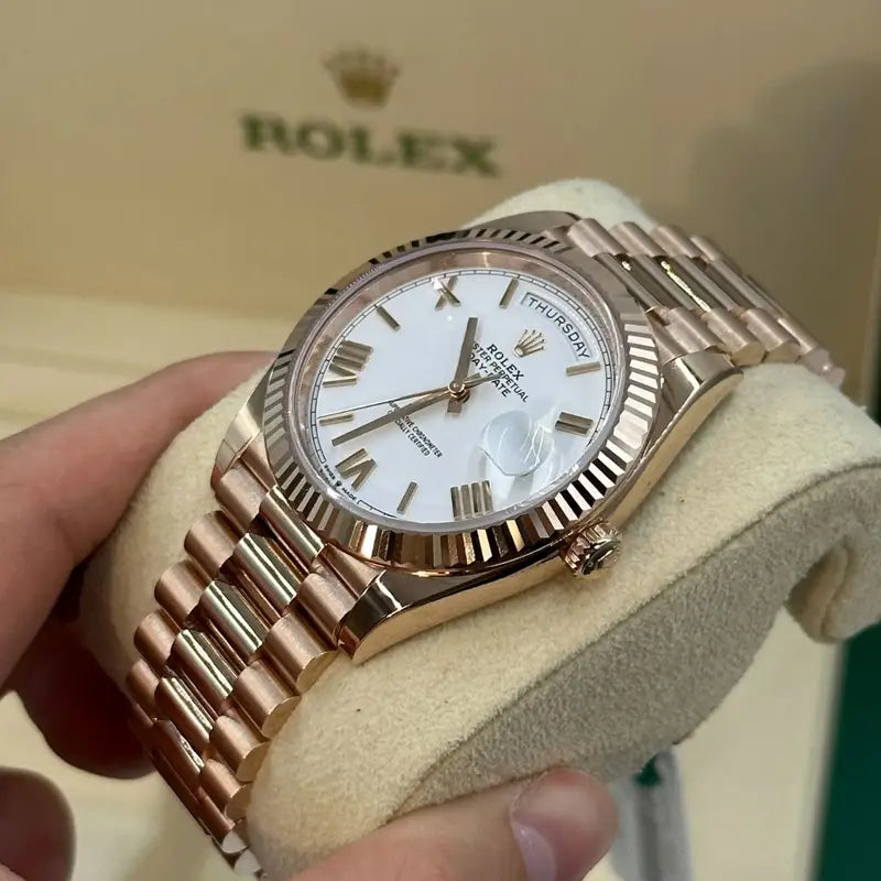 Rolex Day-Date Rose gold with a white Roman numeral dial and a fluted bezel for women
