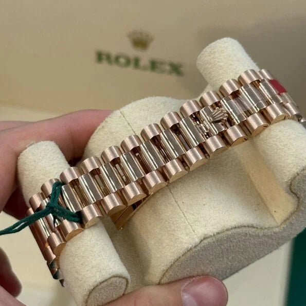 Rolex Day-Date Rose gold with a white Roman numeral dial and a fluted bezel for women