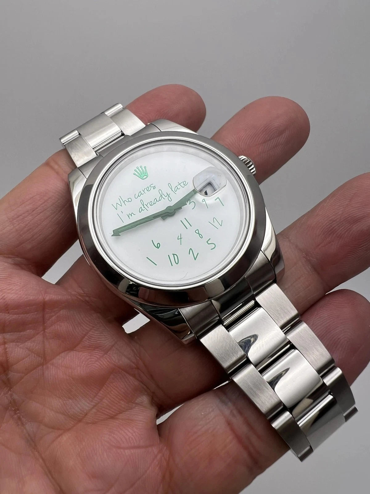 Rolex customized version featuring a white dial with the phrase "Who Cares I'm Already Late" and scattered numerals Milgauss featuring a white dial with the phrase "Who Cares I'm Already Late" and scattered numerals